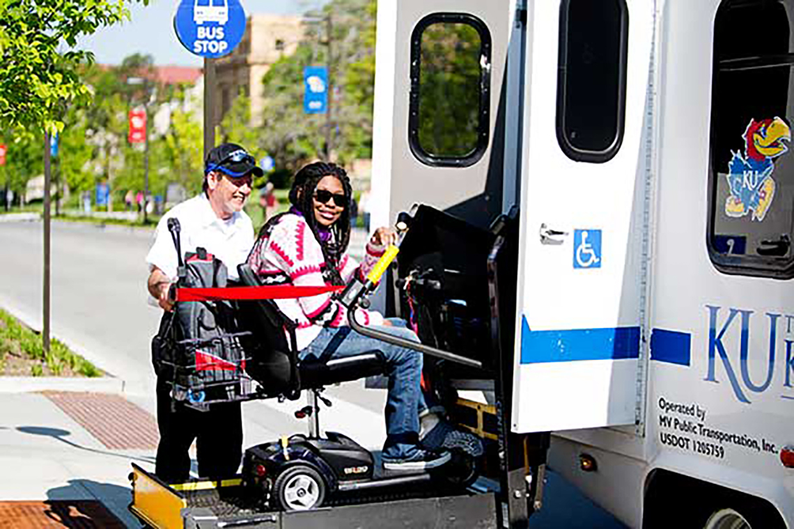 Student being helped into KU JayLIft Bus