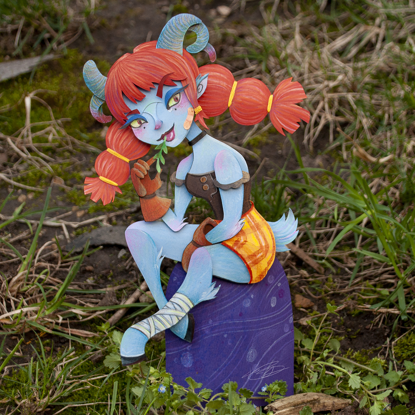 Cut paper Satyr sitting on a rock chewing hay.