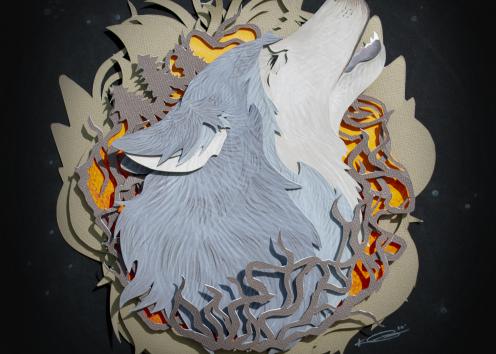 Cut paper wolf head howling through a wood-like garland.